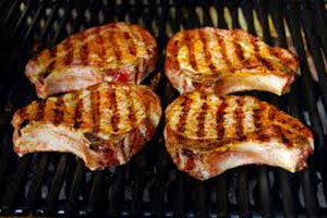 picture of pork chops grilling