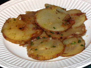 picture of potatoes sliced with onions cooked