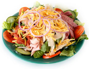 picture of a salad with the usual toppings with ham and turkey