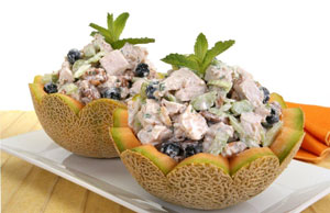 A melon filled with chicken salad mixture