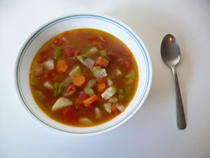 a bowl of soup with nothing but vegetables